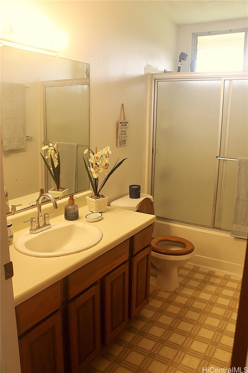17-303 Pilikino Road Kurtistown, HI 96760 - Photo 13 of 19 a bathroom with a double vanity sink and a mirror