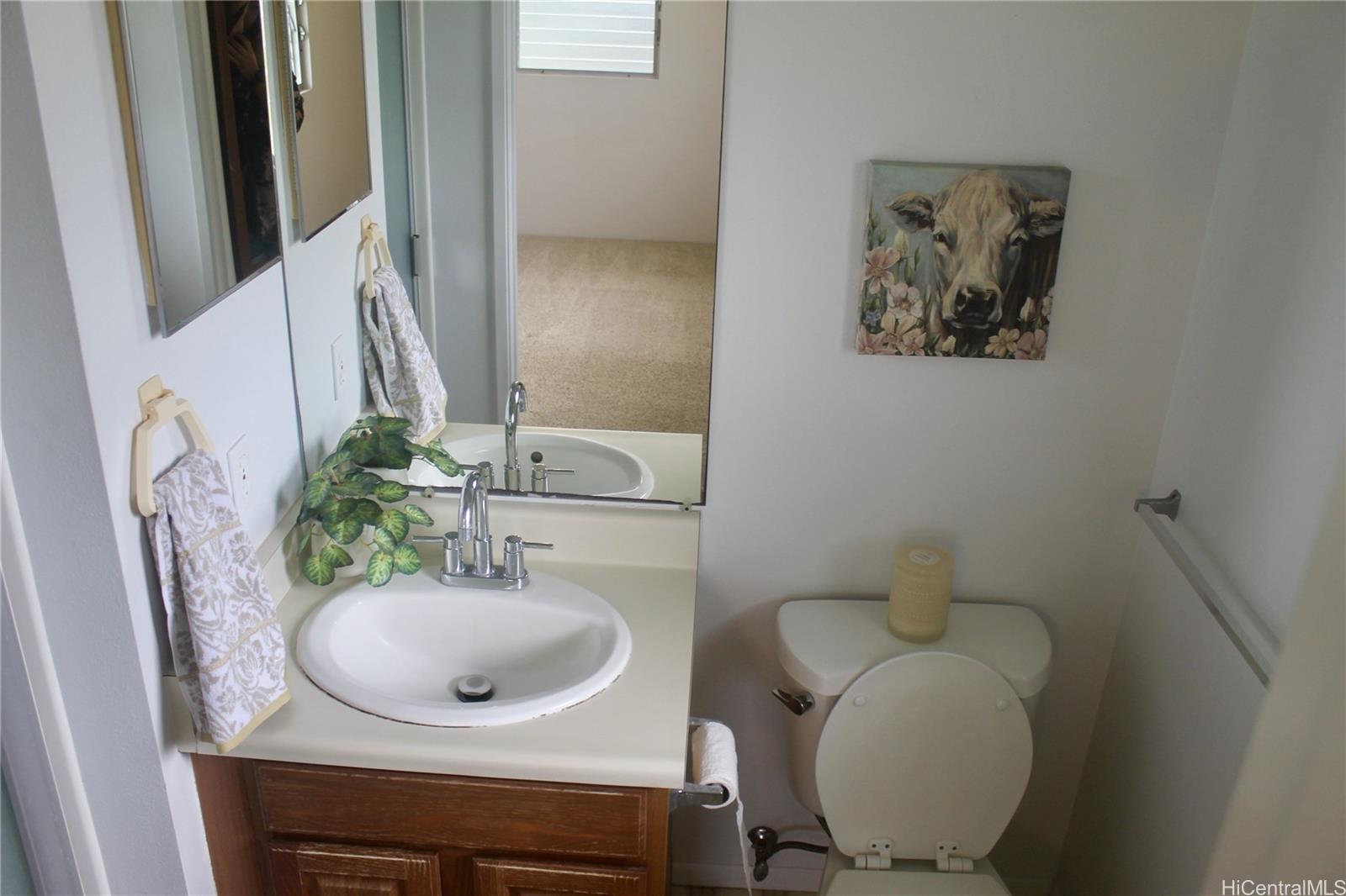 17-303 Pilikino Road Kurtistown, HI 96760 - Photo 15 of 19 a bathroom with a toilet sink and mirror