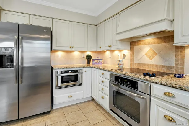 a kitchen with granite countertop a stainless steel appliances cabinets and counter space