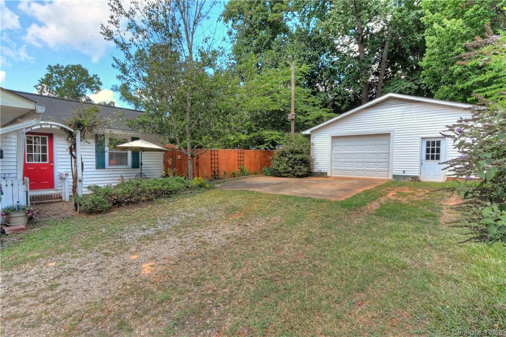5700 Paw Creek Road Charlotte, NC 28214 - Photo 2 of 19 a backyard of a house with plants and large tree