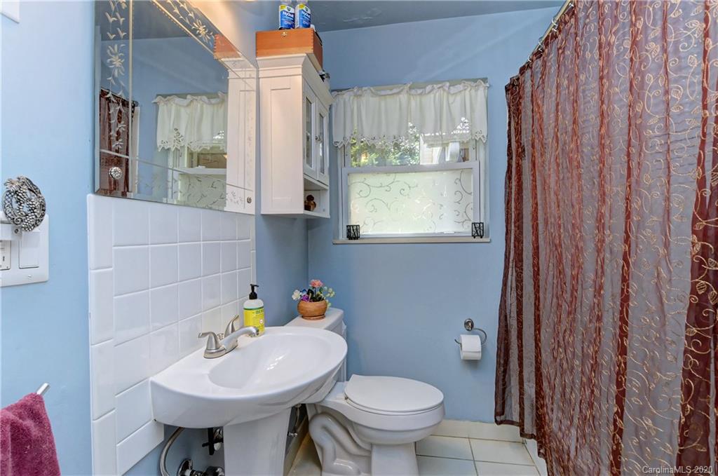 5700 Paw Creek Road Charlotte, NC 28214 - Photo 13 of 19 a bathroom with a sink a toilet and a mirror