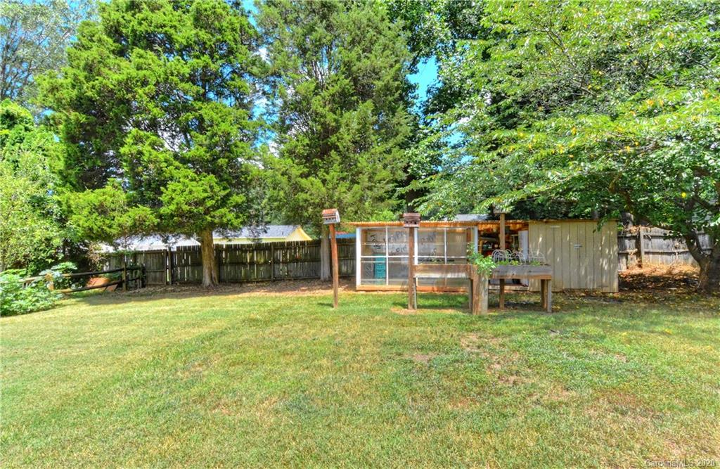 5700 Paw Creek Road Charlotte, NC 28214 - Photo 16 of 19 a view of a house with a yard and sitting area