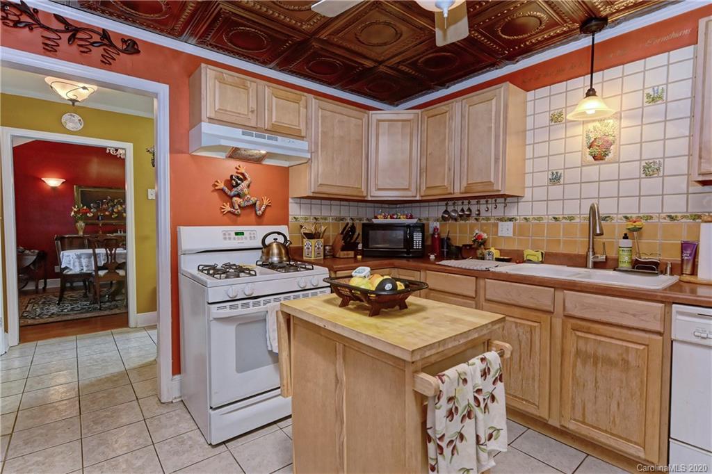 5700 Paw Creek Road Charlotte, NC 28214 - Photo 5 of 19 a kitchen with a stove a sink a refrigerator and cabinets