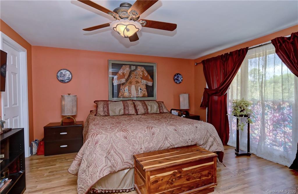 5700 Paw Creek Road Charlotte, NC 28214 - Photo 6 of 19 a bedroom with a bed and a chandelier
