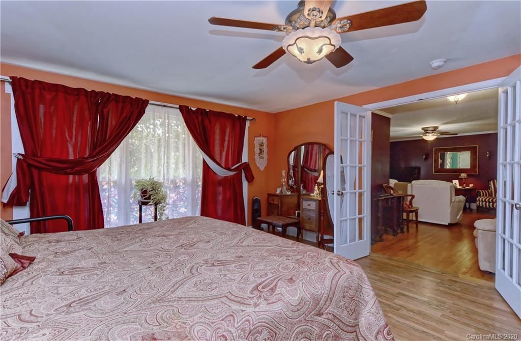 5700 Paw Creek Road Charlotte, NC 28214 - Photo 7 of 19 a bed room with a bed and a mirror
