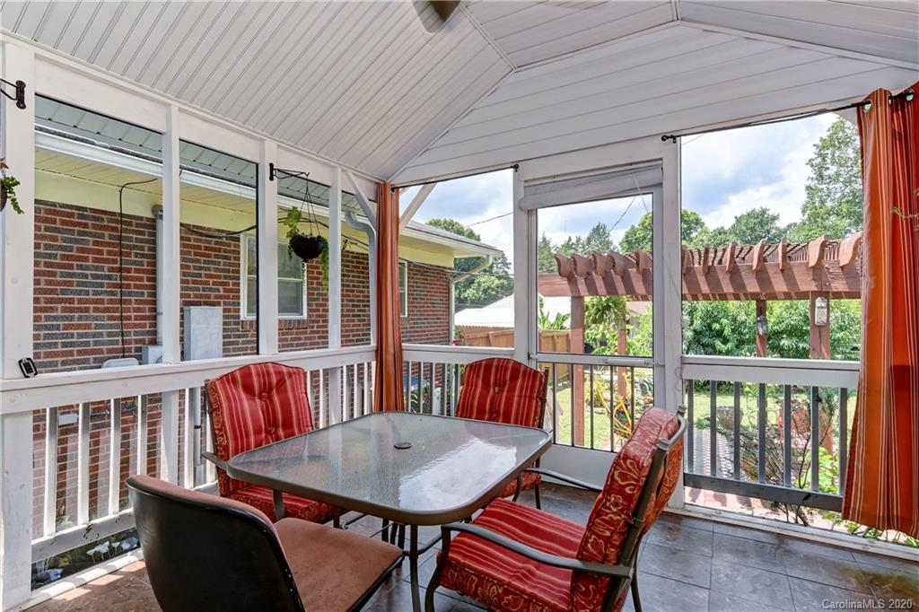 5700 Paw Creek Road Charlotte, NC 28214 - Photo 10 of 19 a view of a dining room with furniture large windows and wooden floor
