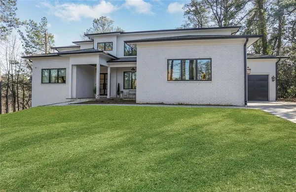 a view of a house with a yard and sitting area
