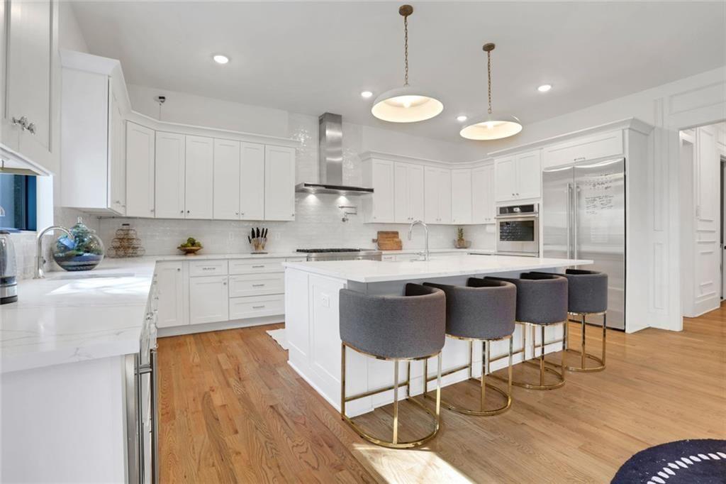 1200 Moores Mill Road Northwest Atlanta, GA 30327 - Photo 29 of 73 a kitchen with stainless steel appliances kitchen island granite countertop a dining table chairs and sink