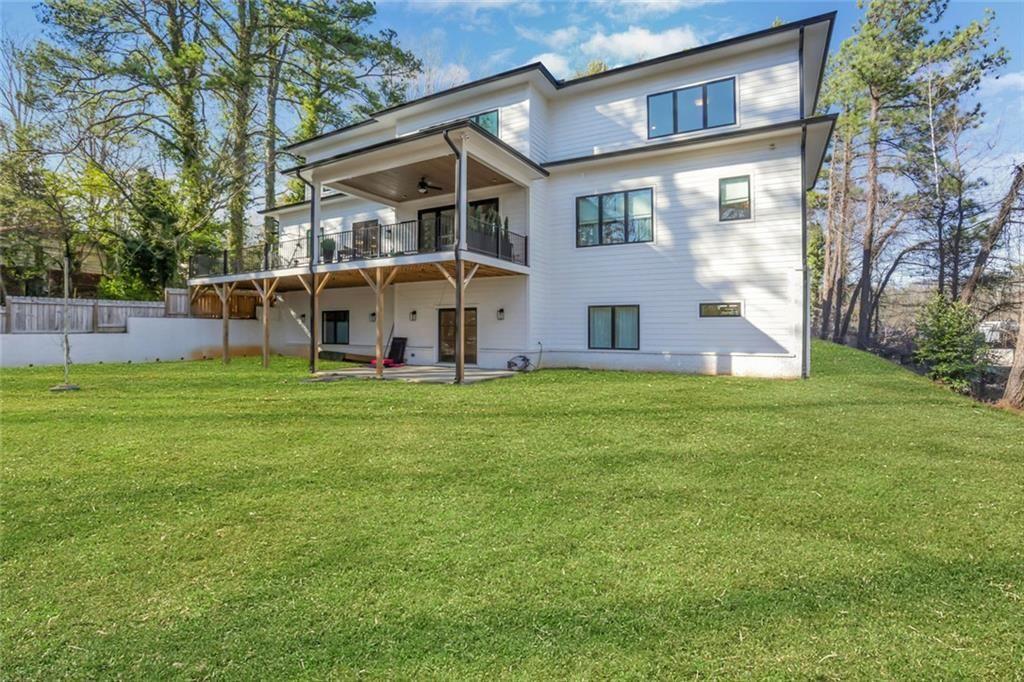 1200 Moores Mill Road Northwest Atlanta, GA 30327 - Photo 7 of 73 a view of a house with a yard and sitting area