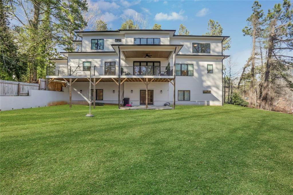 1200 Moores Mill Road Northwest Atlanta, GA 30327 - Photo 8 of 73 a view of a house with a yard and sitting area