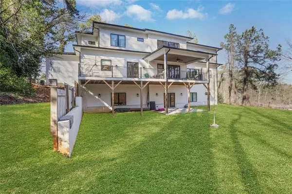 a kitchen with stainless steel appliances kitchen island granite countertop a dining table chairs and sink