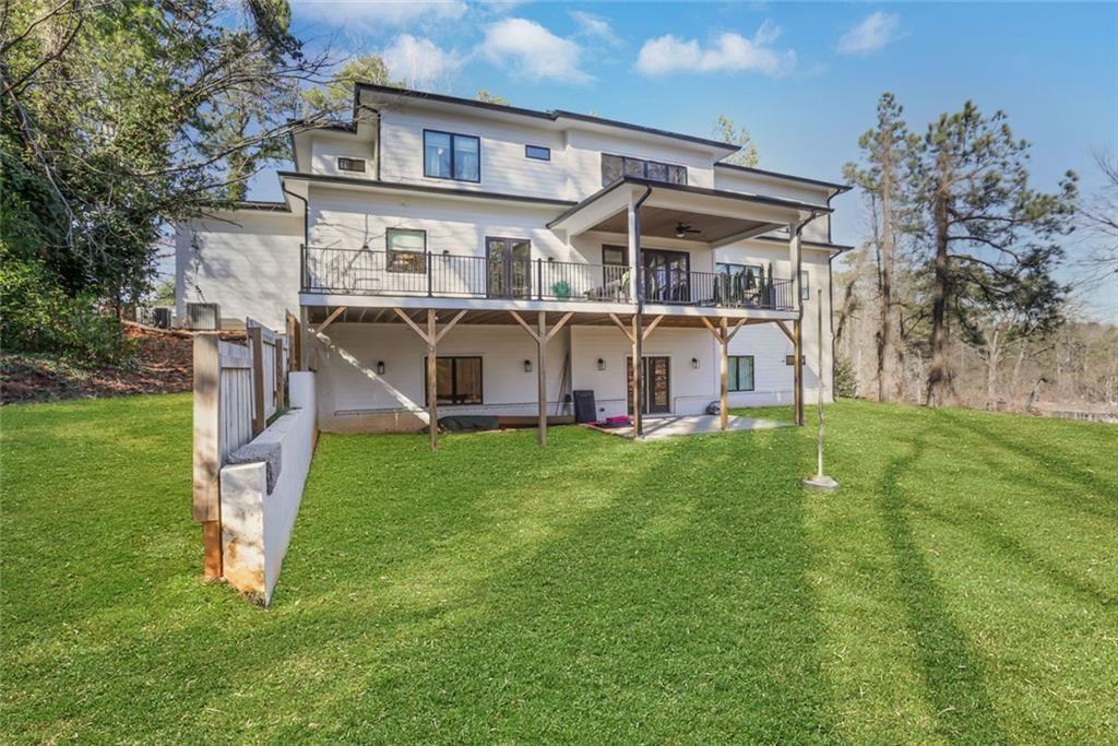 1200 Moores Mill Road Northwest Atlanta, GA 30327 - Photo 9 of 73 a view of a house with a big yard and large tree