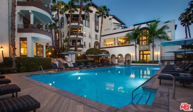 a view of a house with pool and chairs