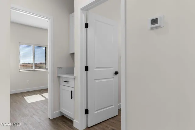 a view of a hallway with wooden floor