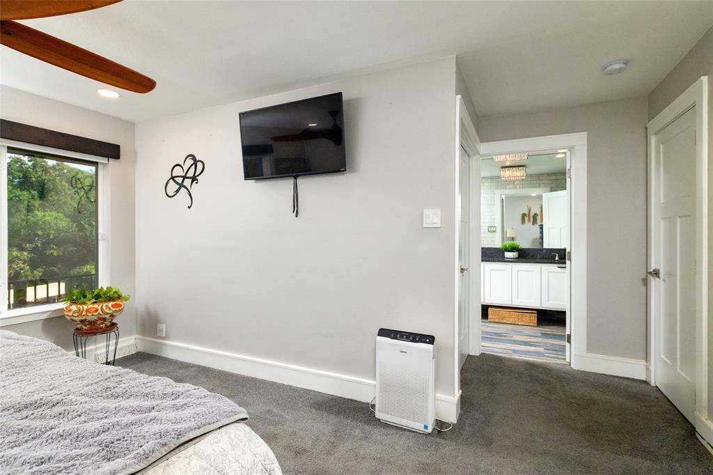 205 Timberlake Drive Azle, TX 76020 - Photo 19 of 40 a bedroom with a bed and a television