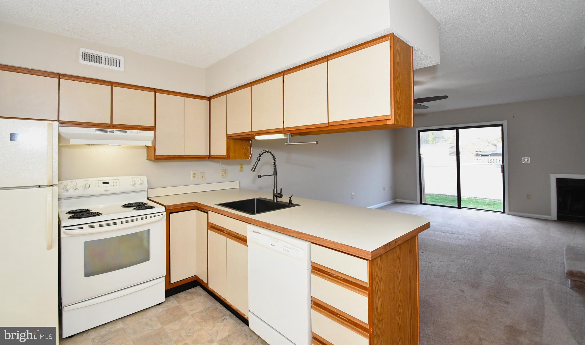9815 Stephen Decatur Highway, Unit 3 Ocean City, MD 21842 - Photo 5 of 23 a kitchen with a stove a sink and a refrigerator
