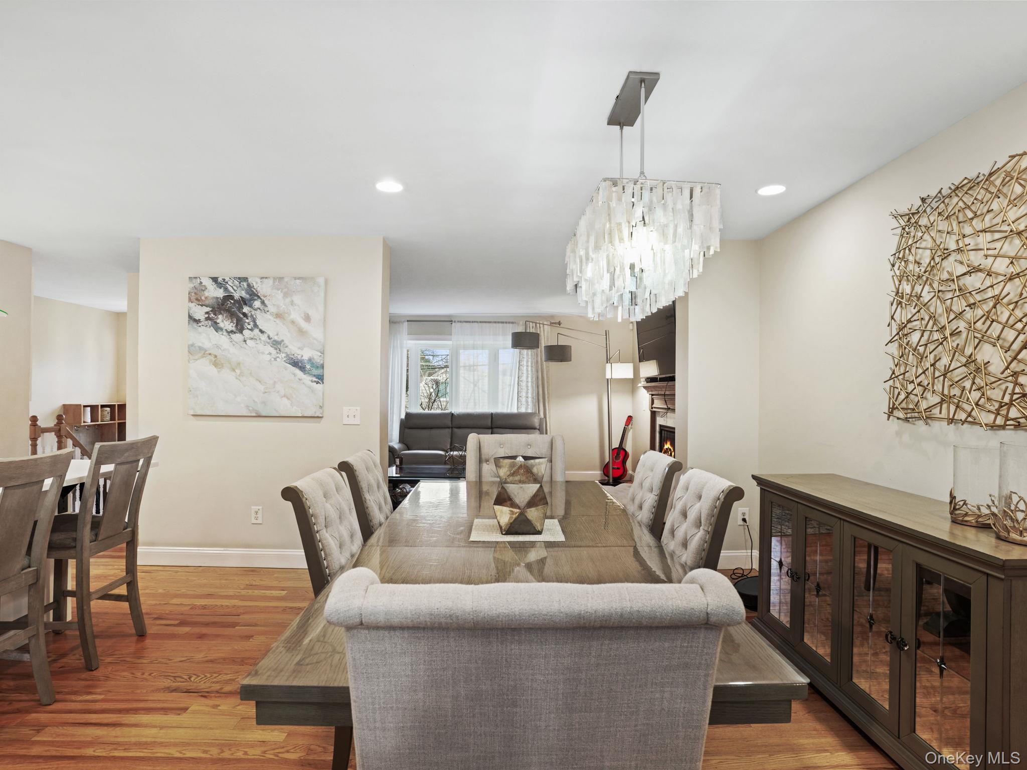 38 Kathwood Road White Plains, NY 10607 - Photo 12 of 44 Dining area with a lit fireplace, light wood-style floors, and recessed lighting