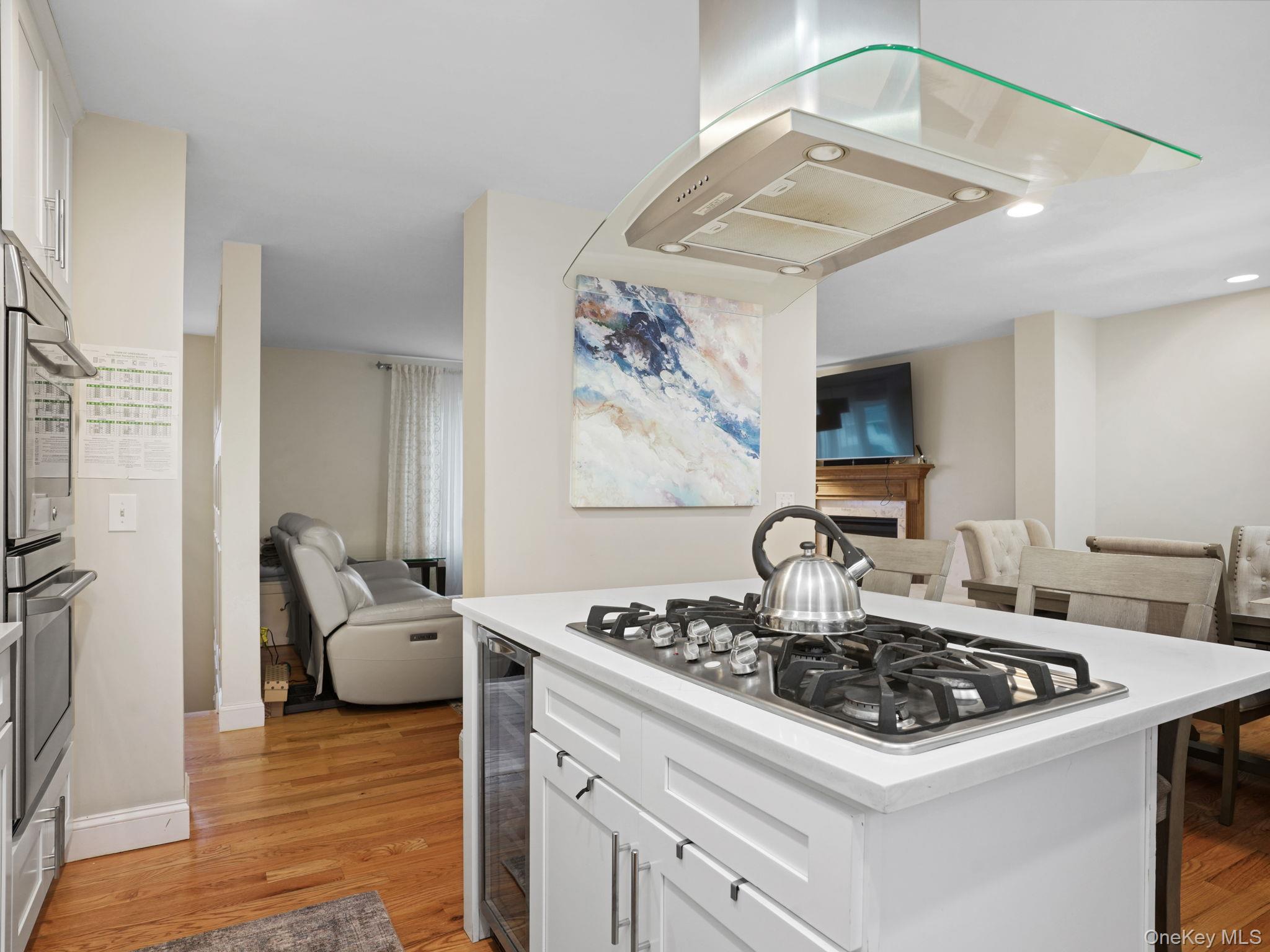 38 Kathwood Road White Plains, NY 10607 - Photo 43 of 44 Kitchen with open floor plan, island range hood, white cabinets, and a center island
