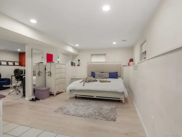 a spacious bedroom with a bed and a couch