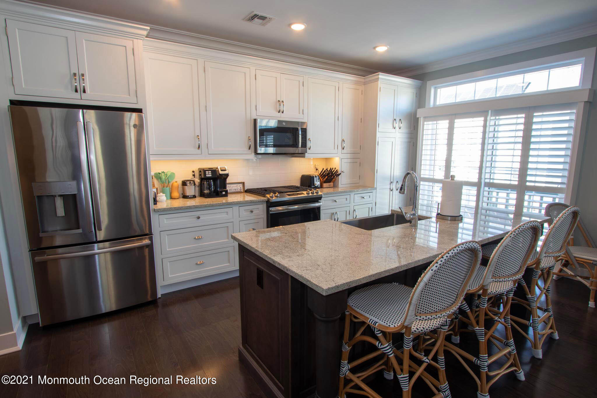 13 Surf Road Seaside Heights, NJ 08751 - Photo 23 of 64 a kitchen with stainless steel appliances granite countertop a refrigerator a stove a sink a dining table and chairs