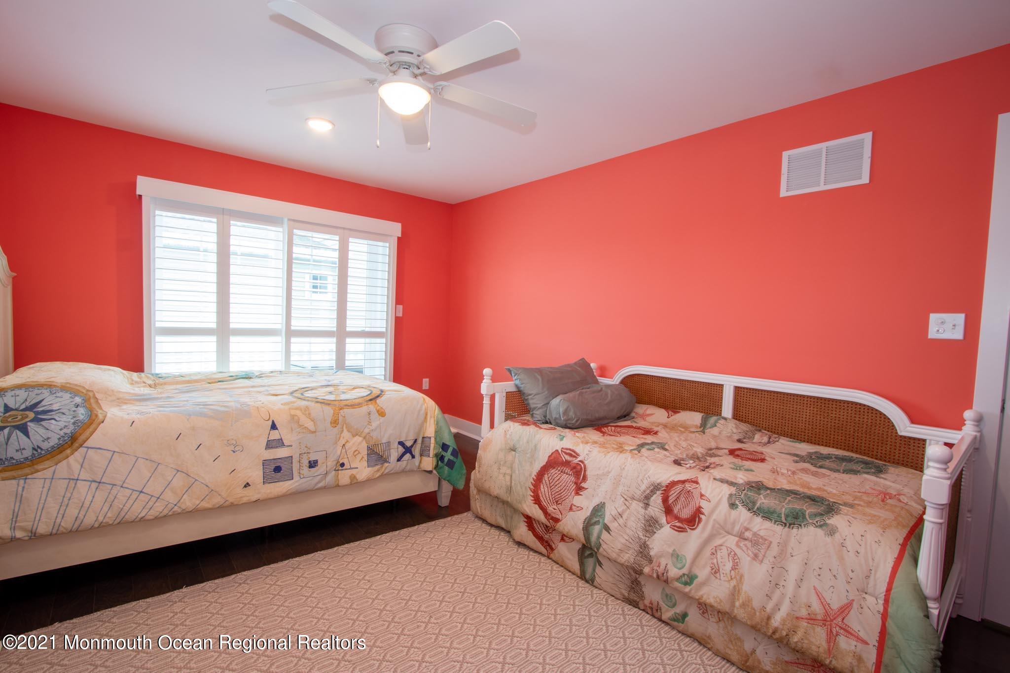 13 Surf Road Seaside Heights, NJ 08751 - Photo 33 of 64 a bedroom with a large bed and two window
