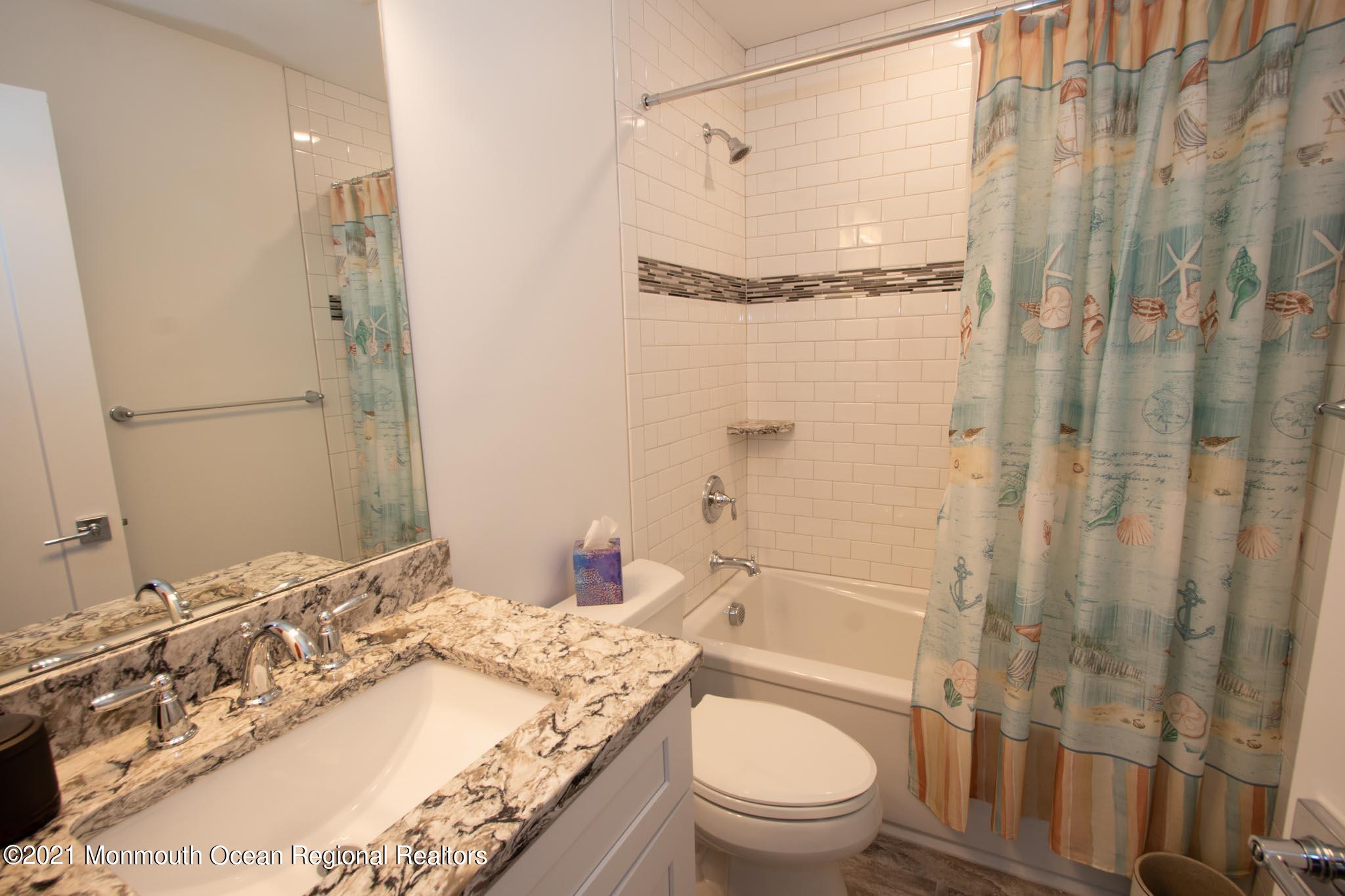 13 Surf Road Seaside Heights, NJ 08751 - Photo 35 of 64 a bathroom with a granite countertop sink toilet and shower