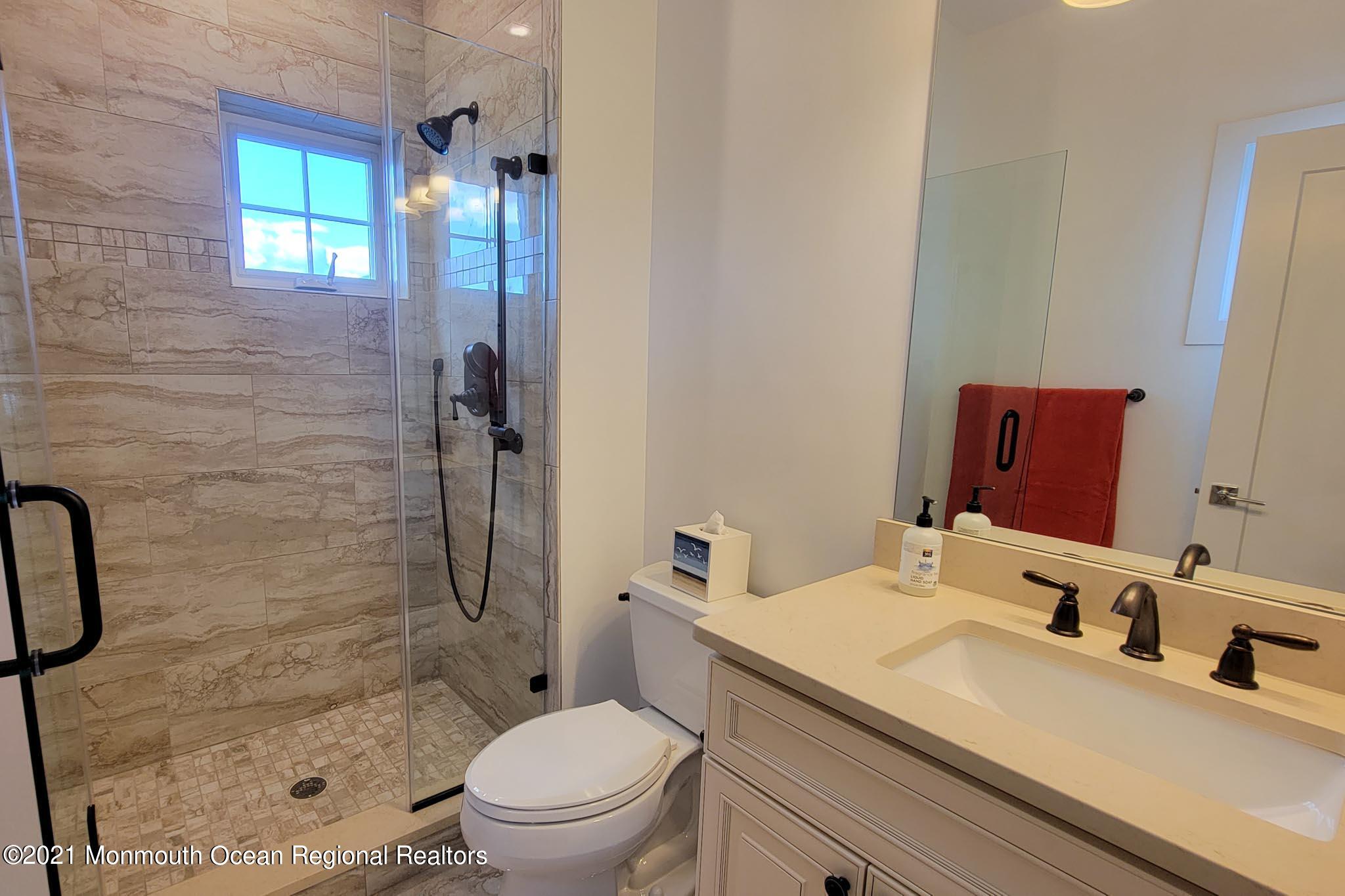 13 Surf Road Seaside Heights, NJ 08751 - Photo 41 of 64 a bathroom with a granite countertop sink a toilet and shower