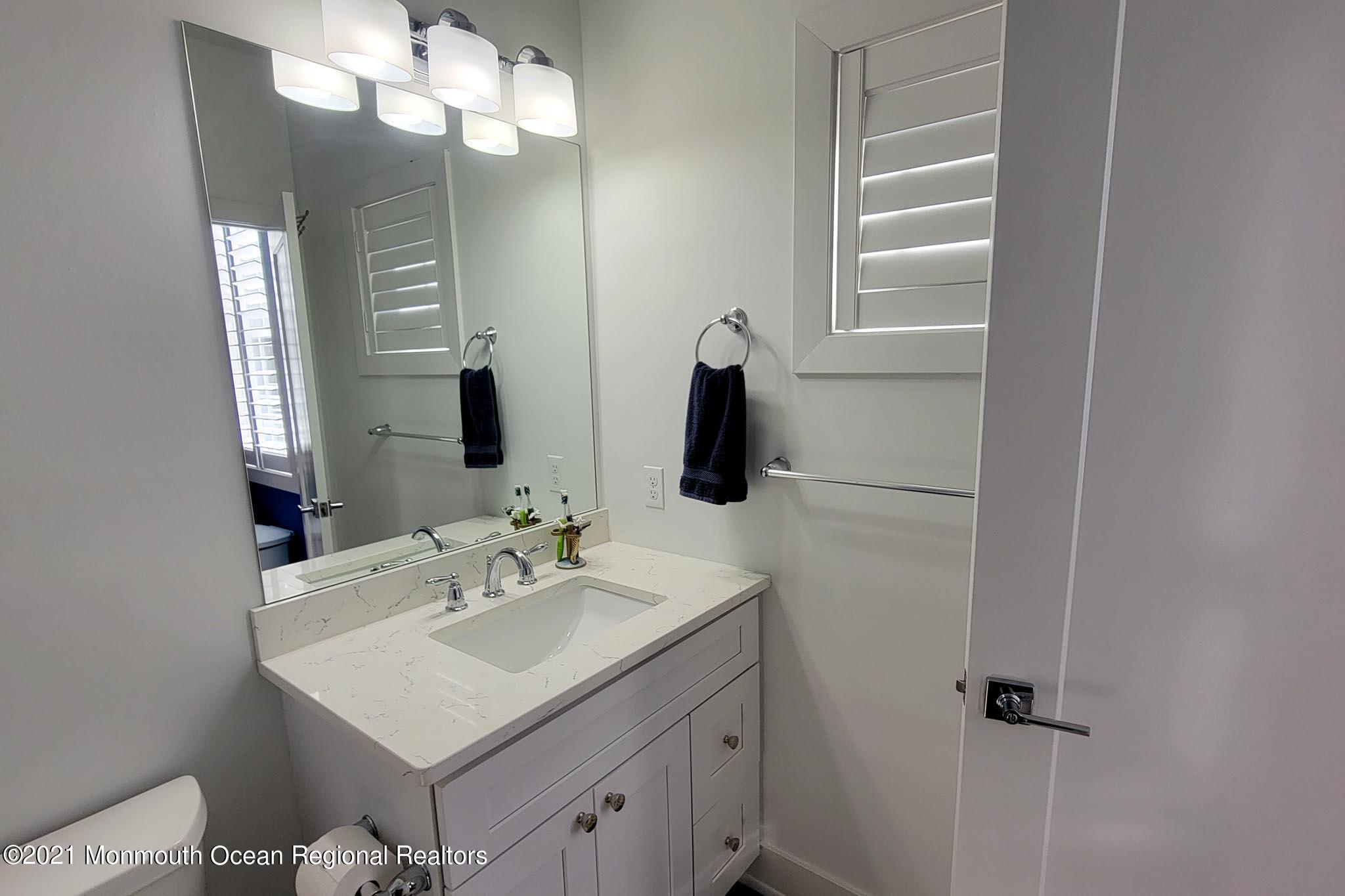13 Surf Road Seaside Heights, NJ 08751 - Photo 49 of 64 a bathroom with a sink vanity and a mirror