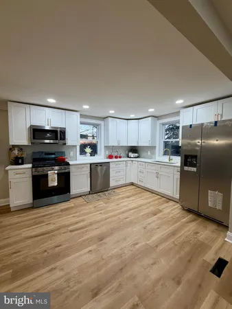 a large kitchen with cabinets and stainless steel appliances