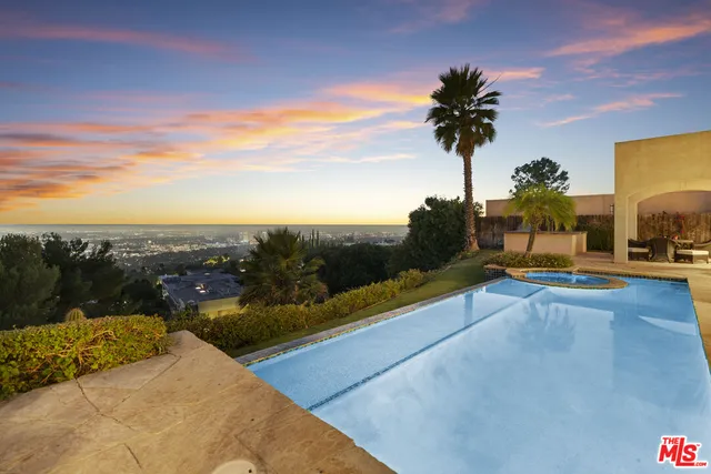 a view of a swimming pool with outdoor seating