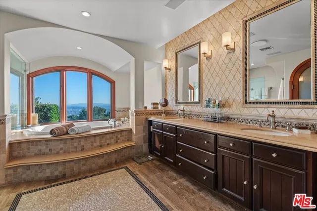 a spacious bathroom with a double vanity sink and a large mirror