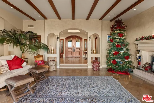 a living room with furniture and flowers