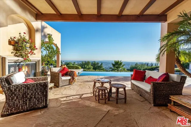 a view of a patio with couches and potted plants