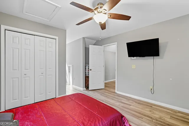 a bedroom with a bed and a flat screen tv