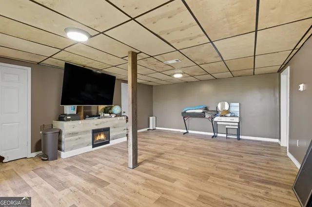 a view of a livingroom with furniture and a flat screen tv