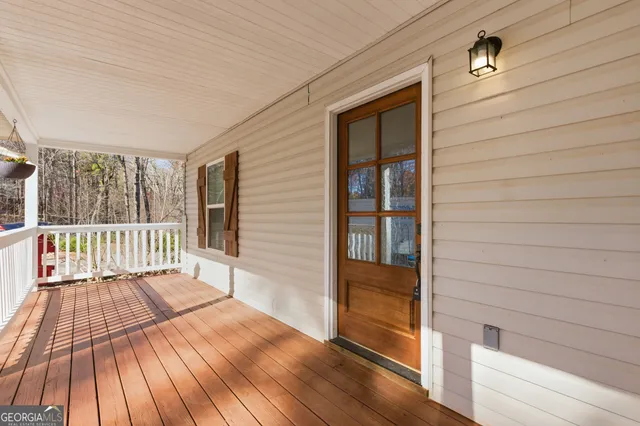 a view of deck with a floor to ceiling window and wooden floor