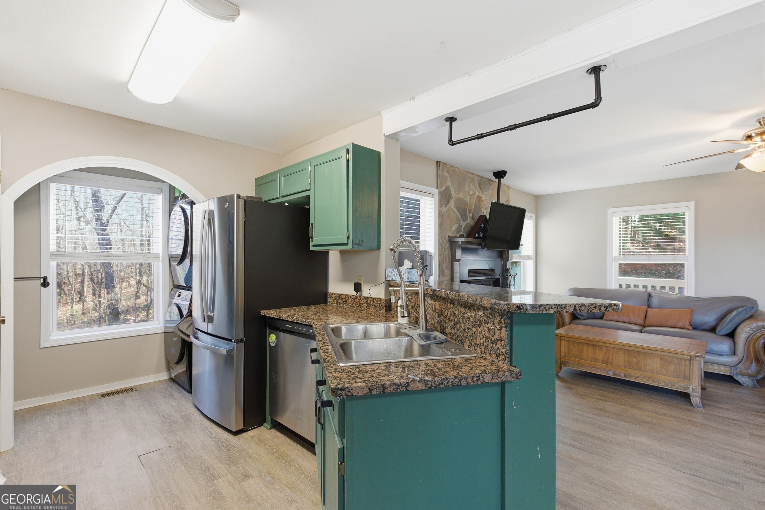 1947 Ivy Mountain Road Clarkesville, GA 30523 - Photo 10 of 48 a kitchen with stainless steel appliances granite countertop a refrigerator a stove and a sink with couches
