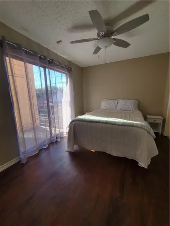 a bedroom with a bed and a large window