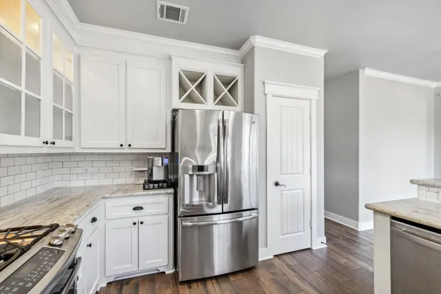 a kitchen with cabinets and stainless steel appliances