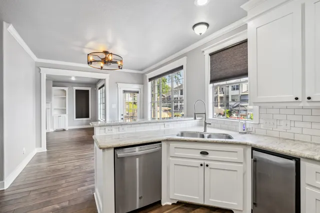 a kitchen with stainless steel appliances granite countertop a sink and cabinets