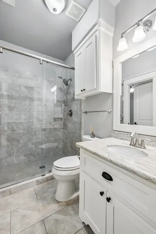 a bathroom with a sink a toilet and a mirror