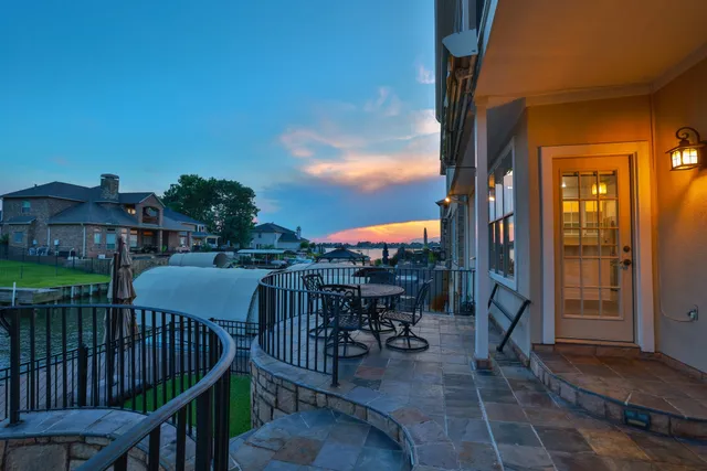 a balcony with table and chairs