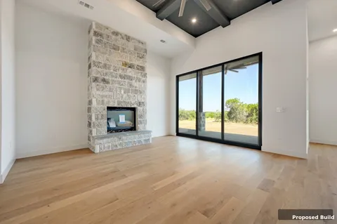 a view of an empty room with a fireplace and a window