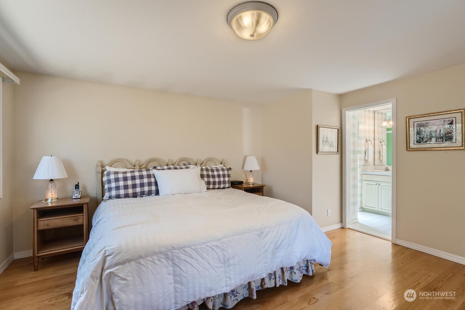 12823 Spanaway Loop Road South Tacoma, WA 98444 - Photo 16 of 38 a bedroom with a bed and a lamp