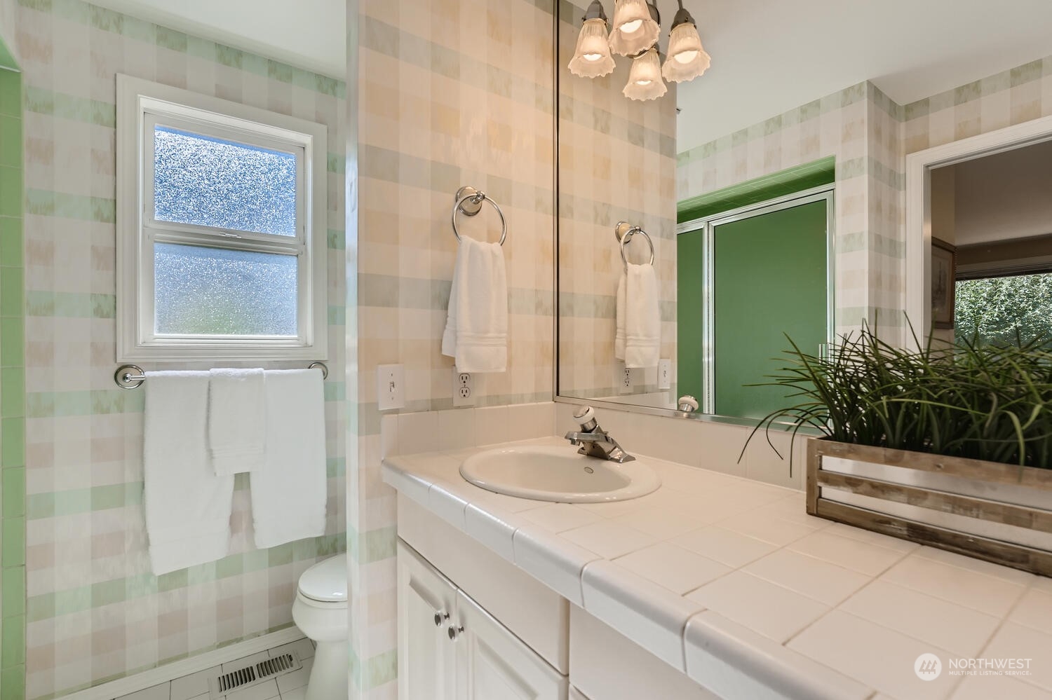 12823 Spanaway Loop Road South Tacoma, WA 98444 - Photo 19 of 38 a bathroom with a sink a toilet and shower