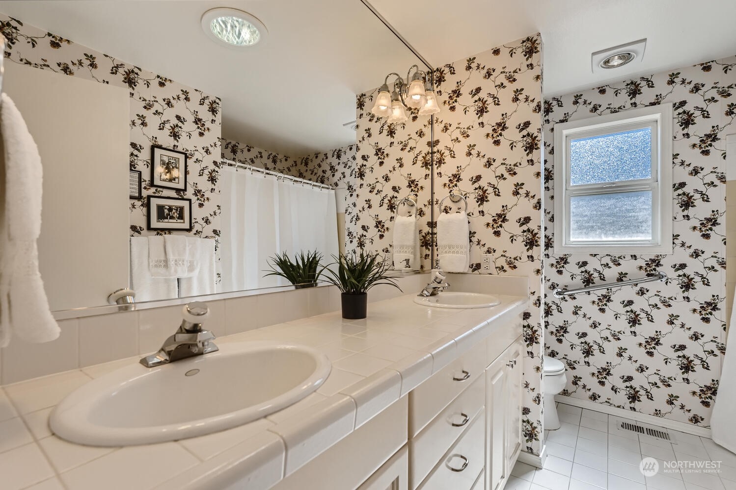 12823 Spanaway Loop Road South Tacoma, WA 98444 - Photo 22 of 38 a bathroom with a sink and a mirror