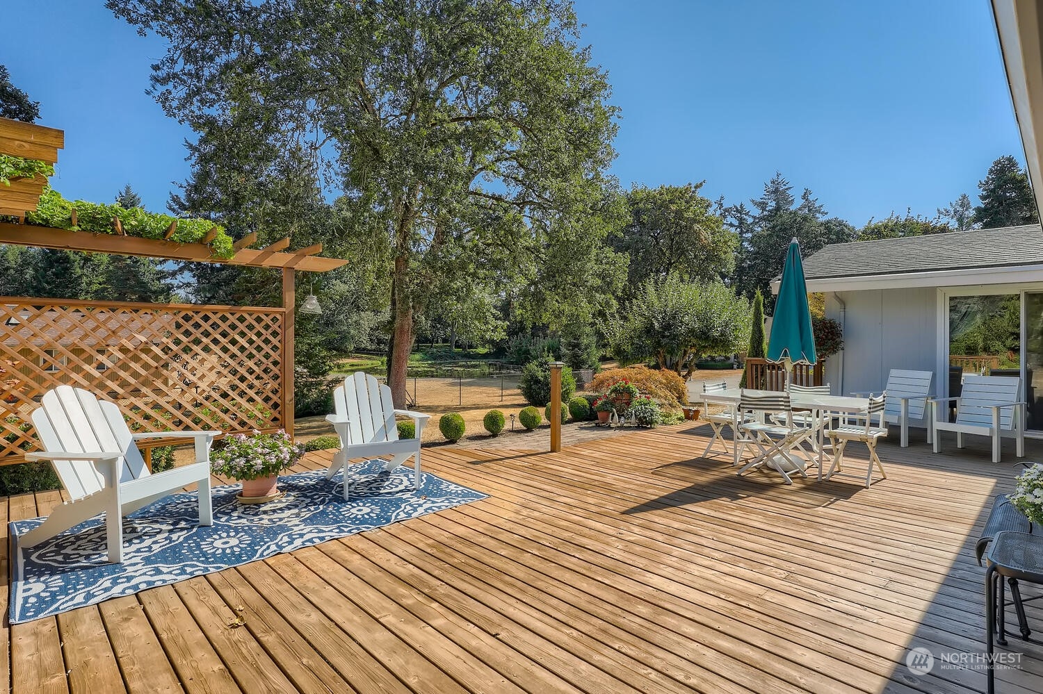 12823 Spanaway Loop Road South Tacoma, WA 98444 - Photo 24 of 38 a view of a patio with table and chairs and wooden floor