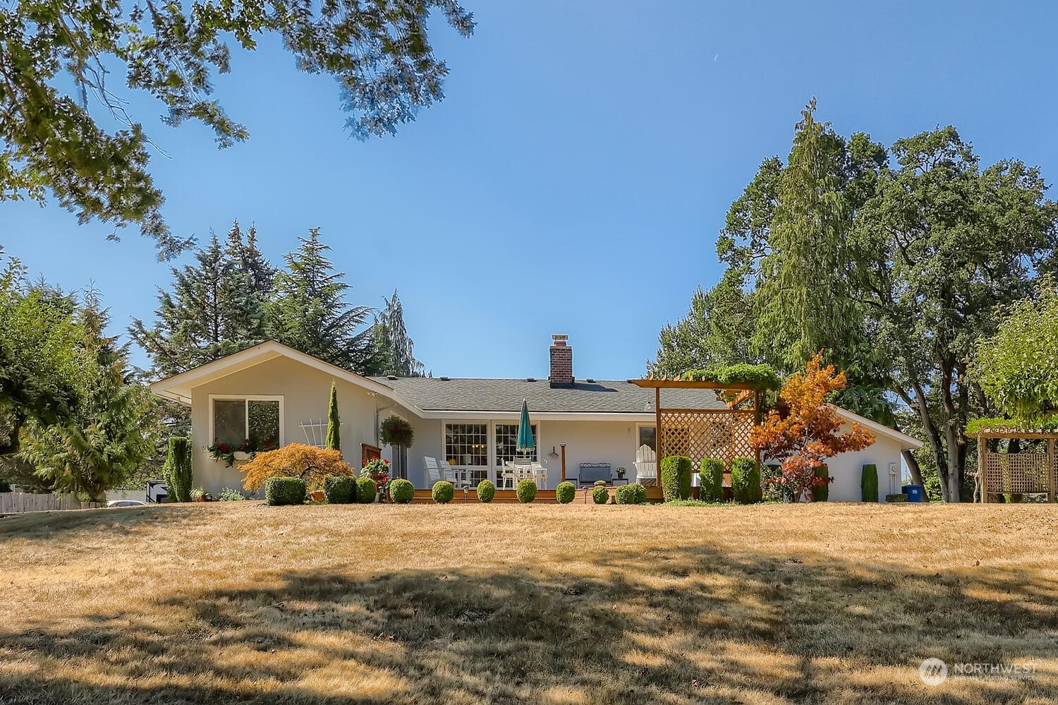 12823 Spanaway Loop Road South Tacoma, WA 98444 - Photo 26 of 38 a front view of a house with a yard and trees