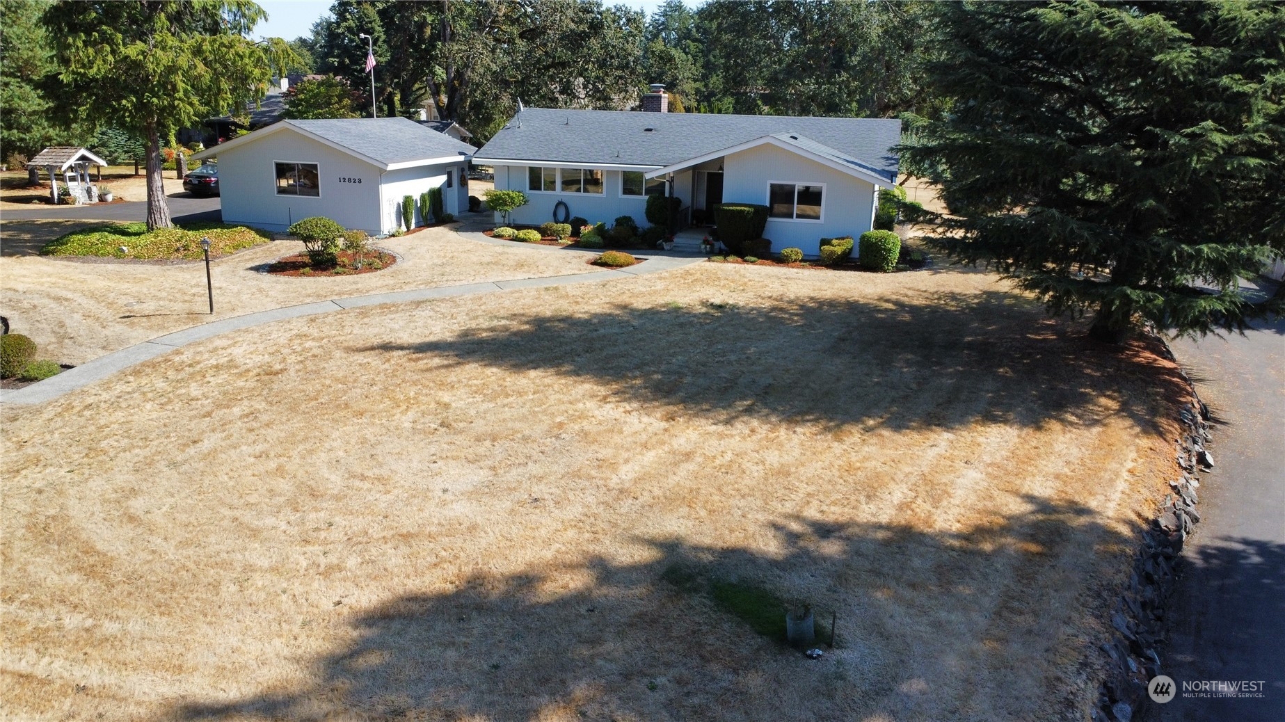 12823 Spanaway Loop Road South Tacoma, WA 98444 - Photo 30 of 38 a front view of a house with a yard covered with snow in front of house