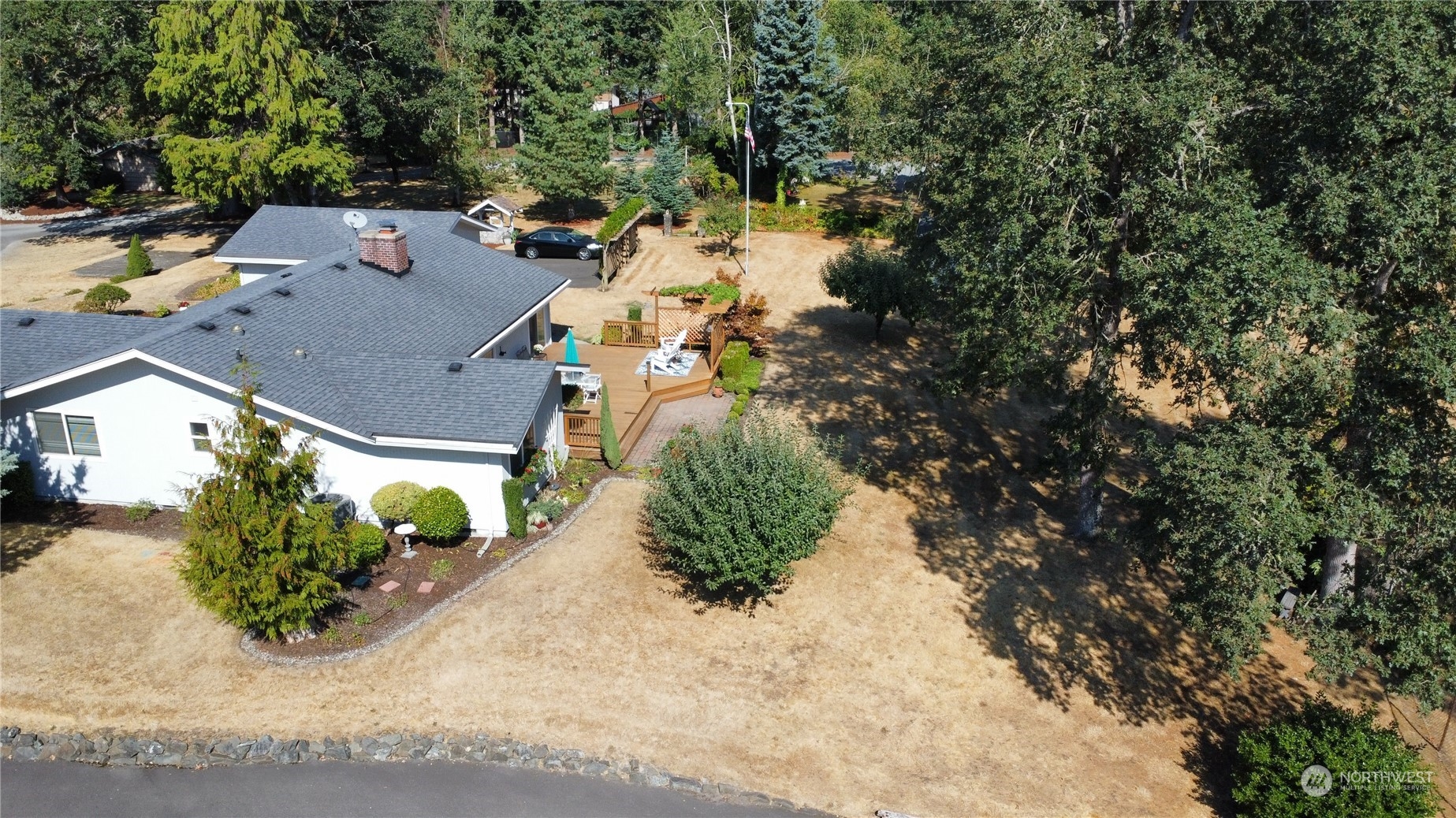 12823 Spanaway Loop Road South Tacoma, WA 98444 - Photo 34 of 38 an aerial view of a house with a yard and mountain view in back